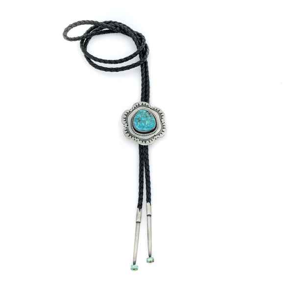 Sterling Silver, Kingman Turquoise and braided leather cord make this unique American Indian bolo tie. Artist: Alex Horst  