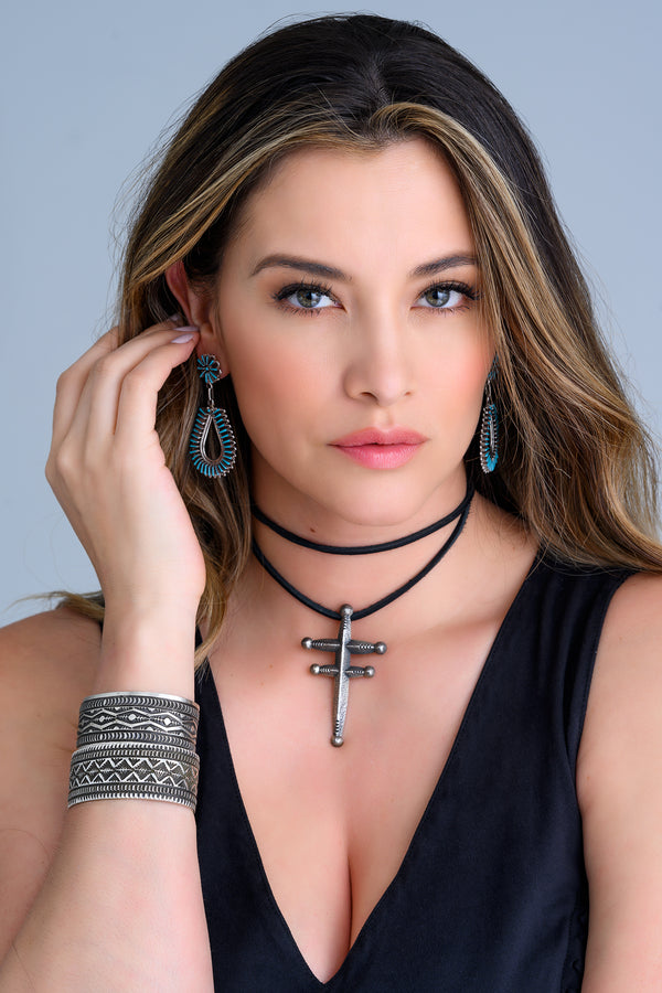 One-of-a-kind hand cut Sleeping Beauty Turquoise chandelier earrings,  sterling silver cross pendant and sterling silver bracelet cuffs made by Native American artists.